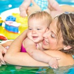 lady with baby in pool